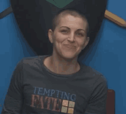 a woman with a shaved head is making a funny face and the words gina devivo 's are above her