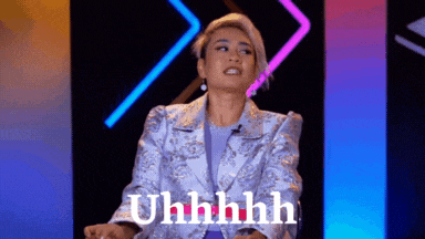 a woman in a purple jacket is sitting on a stage and says uhhhhh