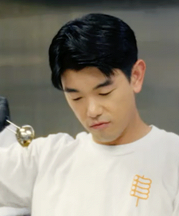 a man wearing a white shirt with a chinese symbol on his chest