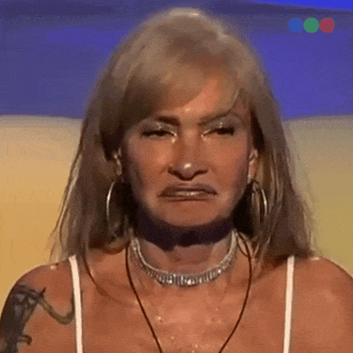 a woman wearing a choker and hoop earrings is making a face