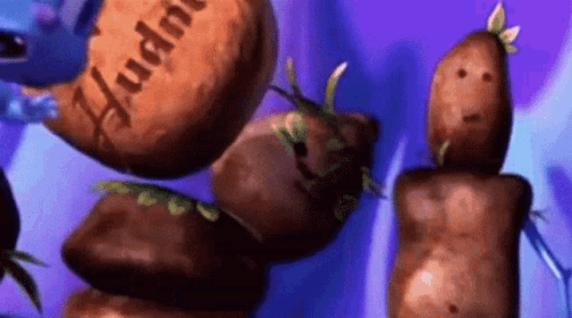 a bunch of potatoes are stacked on top of each other and one of them says huddle