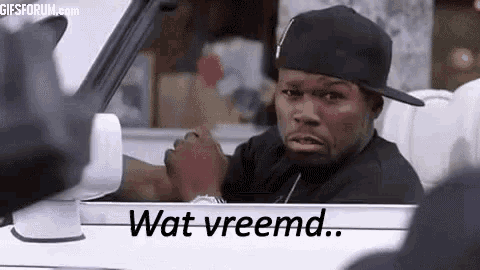 a man in a hat is sitting in a car and says wat vreemd