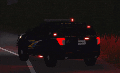 a blaine county sheriff 's car is driving down a road