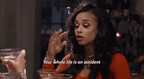 a woman is talking to another woman while holding a martini glass and saying your whole life is an accident .