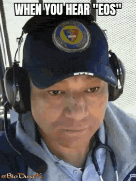 a man wearing headphones and a hat with a patch on it .