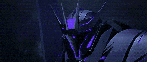 a close up of a robot with purple lights on it 's head and arms .