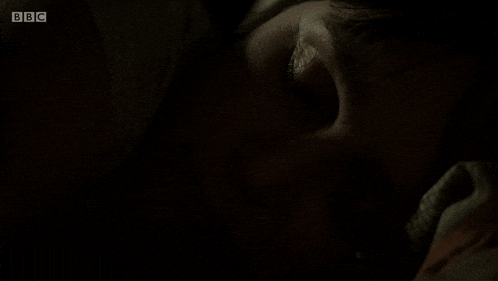 a woman laying in a bed with bbc written on the bottom