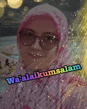 a woman wearing glasses and a hijab says wa ' alaikum salam
