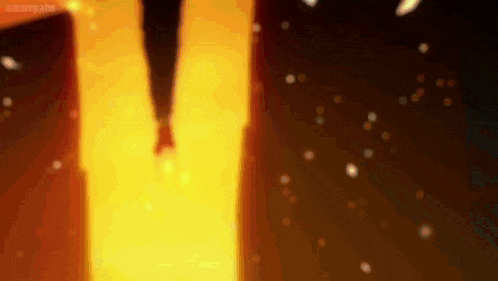 a person is standing in front of a fire in a room .