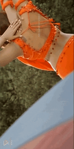 a close up of a woman 's back in an orange dress