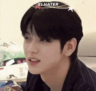a close up of a man 's face with # 1 hater written on his forehead