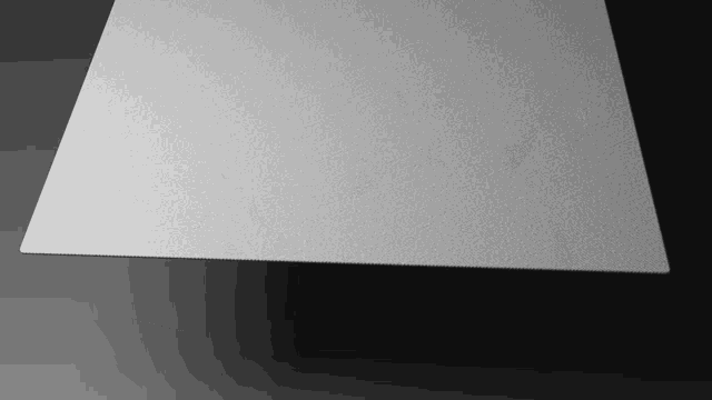 a piece of paper is laying on a black surface