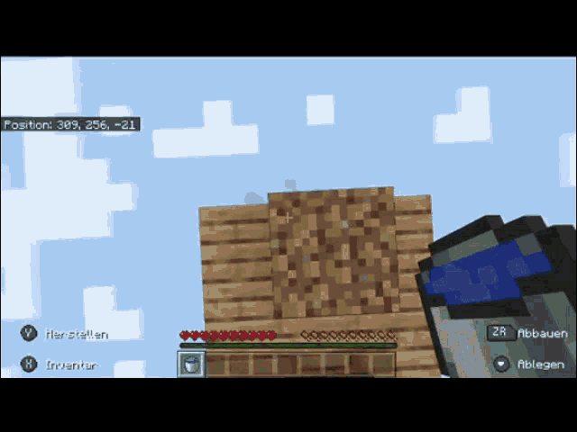 a screenshot of a minecraft game shows a bucket of water and a wooden wall