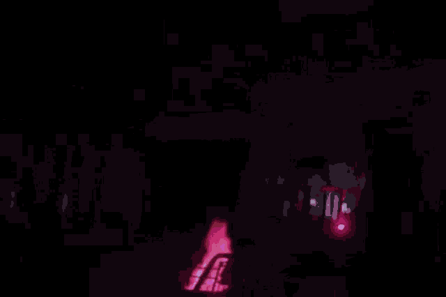 a close up of a pink fireworks display in a dark room .