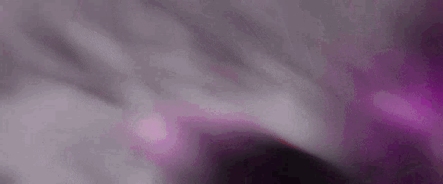 a purple , white and black background with a blurred effect .