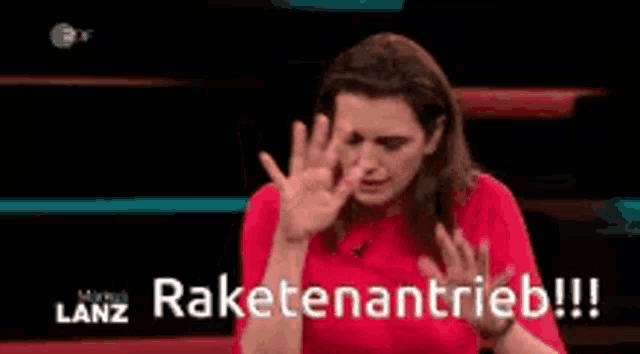 a woman in a red dress is making a funny face with her hands up .