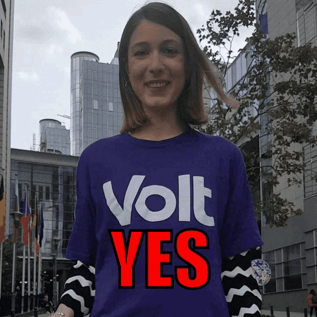 a woman wearing a purple volt yes shirt