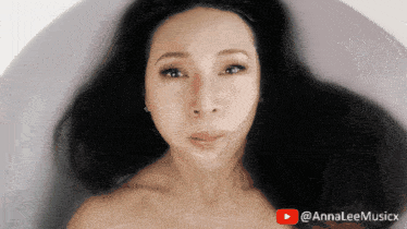 a woman is laying in a bathtub with a youtube logo in the background
