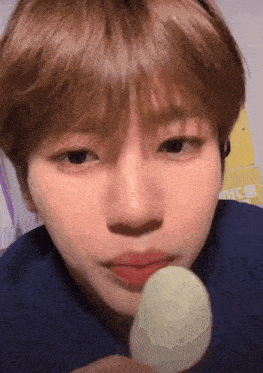 a close up of a person eating a candy bar