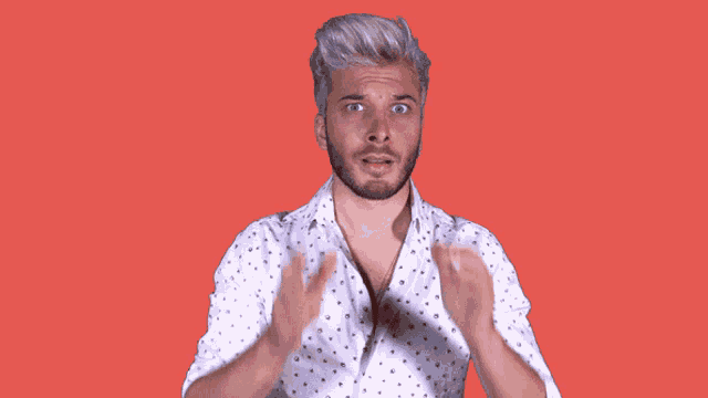 a man wearing a white shirt with polka dots on it