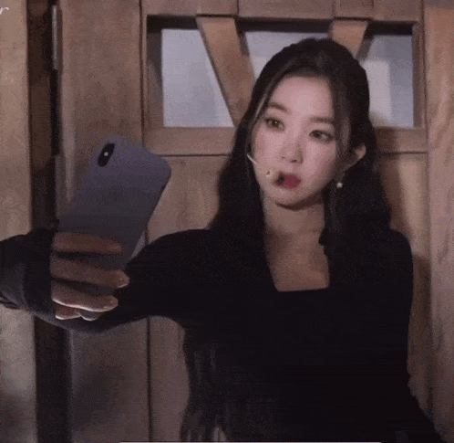 a woman taking a selfie with her phone