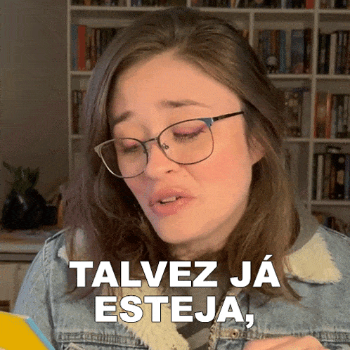 a woman wearing glasses and a denim jacket has the words talvez ja esteja written on her face