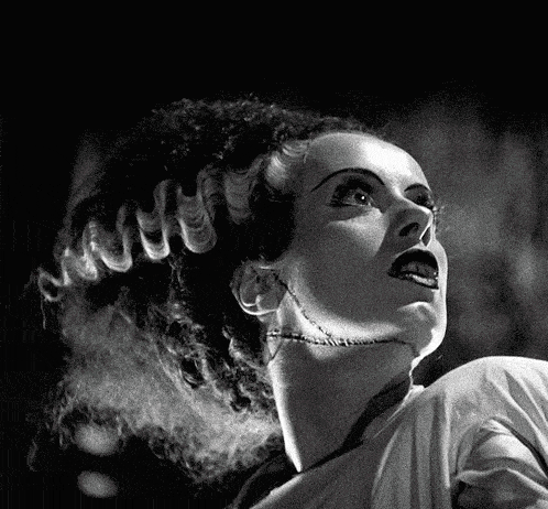 a black and white photo of a woman with a scar on her neck .