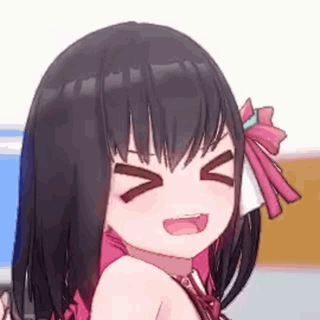 a close up of a girl with black hair and a bow in her hair making a face .