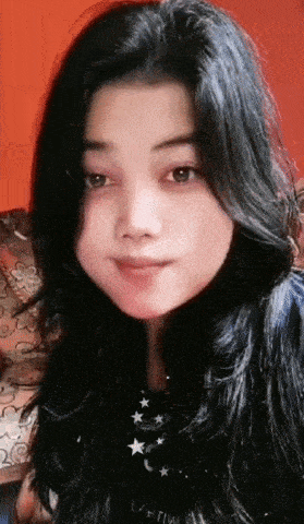 a close up of a woman 's face with black hair