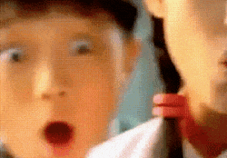 a close up of a child 's face with his mouth open