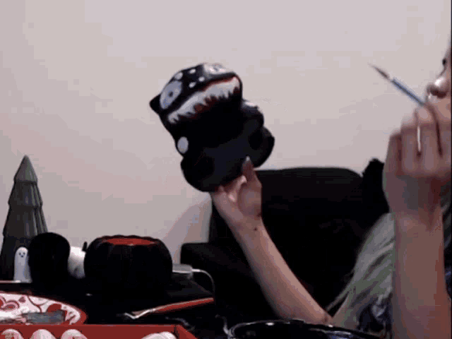a person is holding a stuffed animal and a brush