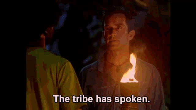 a man with a beard is holding a torch and says the tribe has spoken .