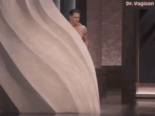 a man in a towel is standing in front of a sign that says dr. vaginsan