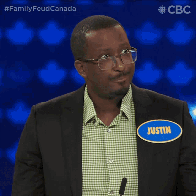 a man in a suit has a name tag that says justin on it