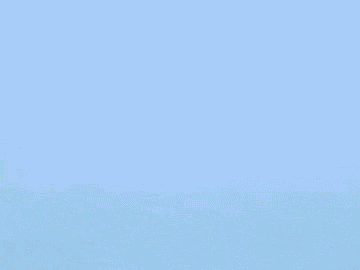 a yellow ball is flying through the air in a field .