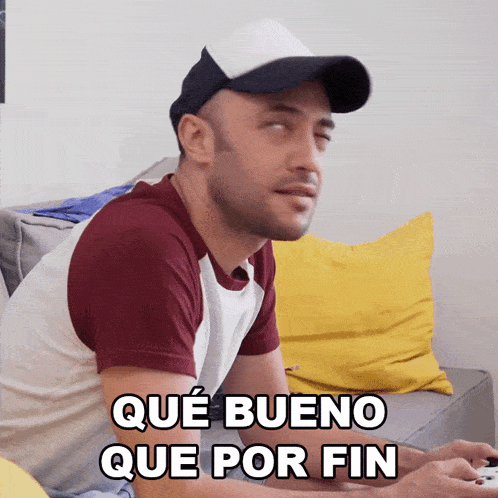 a man playing a video game with the words que bueno que por fin written below him