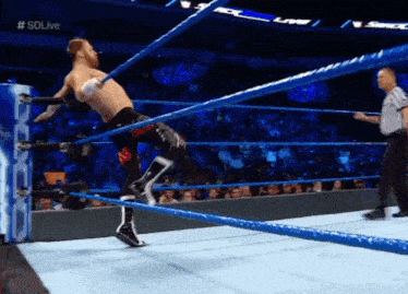 a man in a wrestling ring with #sdlive on the bottom