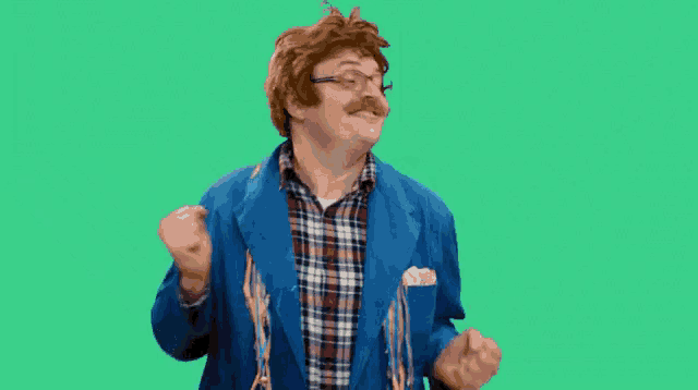 a man in a blue jacket and plaid shirt is making a face