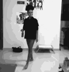 a black and white photo of a woman dancing