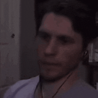 a man wearing headphones is making a funny face .