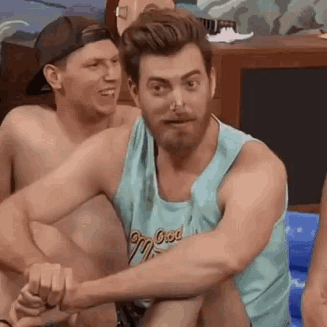 a group of men are sitting next to each other in a room .