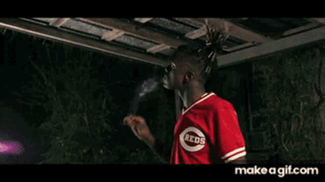 a man in a red shirt is holding a gun with the words shot by david g above him