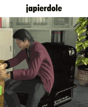 a man in a red sweater is sitting in a chair with the word japierdole above him