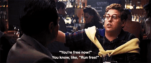 two men are having a conversation in a bar and one of them is saying you 're free now .