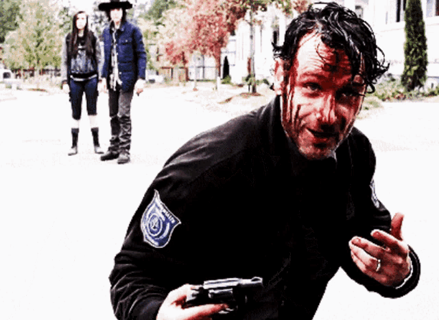 a man holding a gun with a patch on his jacket that says ' security '