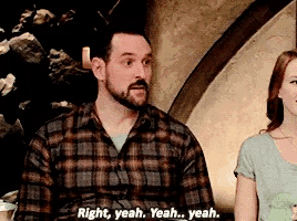 a man in a plaid shirt is talking to a woman and says right yeah yeah yeah yeah