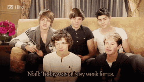 a group of young men are sitting on a couch and one of them says " niall today was a busy week for us "