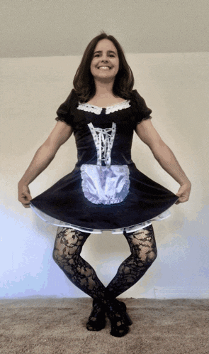 a woman in a maid costume is smiling