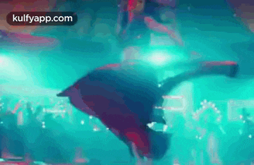 a man is doing a handstand in a club .