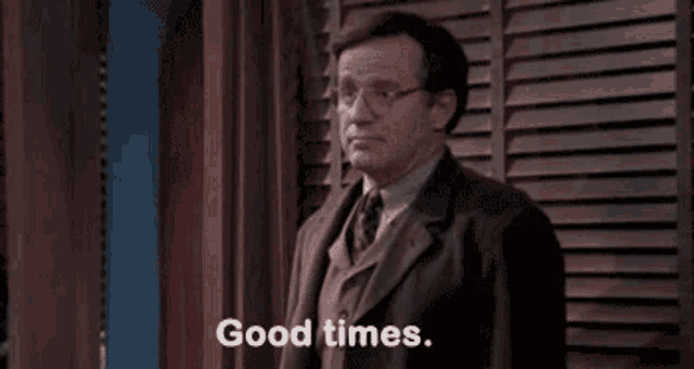 a man in a suit and tie is saying `` good times '' .